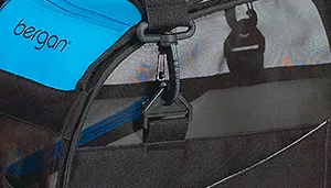 A swatch displays a section of fabric and hardware in blue and black. The blue fabric appears tightly woven with a smooth texture, while adjacent black components appear rigid and matte, consistent with plastic or coated hardware. Stitching is visible where the fabric meets the hardware.