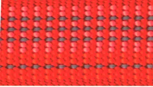 A swatch showing a woven strap in a deep canyon‑red color. The material is textured with small repeating squares formed by intersecting threads in red and reflective gray. The surface has a rugged, structured weave that creates dimensional shading and subtle depth throughout the fabric.