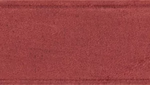 A swatch displaying a flat field of deep brick‑red leather. The surface appears matte with a soft, brushed texture. The color is even throughout, with warm earthy undertones and no patterning or additional elements.