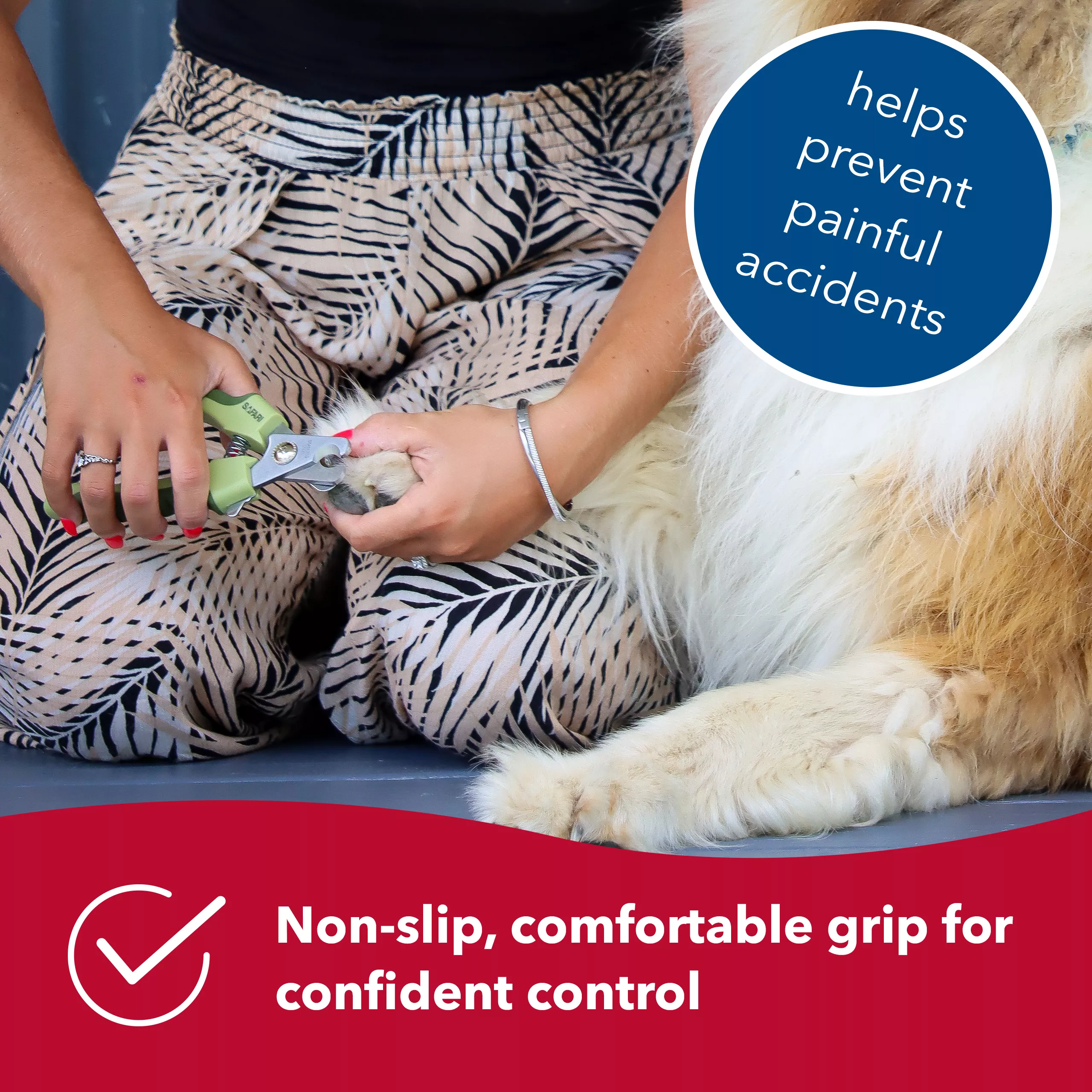 A professional dog nail trimmer being held while trimming a dog’s nails. A red banner with a white checkmark reads: “Non‑slip, comfortable grip for confident control.” A blue circular label reads: “helps prevent painful accidents