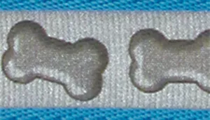 A swatch shows reflective woven fabric with a turquoise bone pattern. The background appears light gray with reflective properties. Turquoise bone shapes repeat across the surface. A turquoise fabric edge runs along the top and bottom of the swatch.