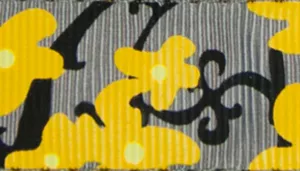A swatch showing a printed pattern of bright yellow buttercup flowers on a medium‑grey background. The yellow blossoms have rounded petals outlined in black, while muted grey leaf and stem shapes fill the surrounding areas. The design blends soft botanical forms with modern, graphic contrast.