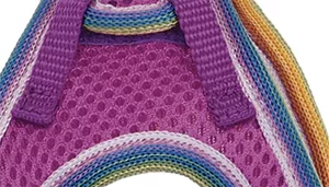 A swatch displays mesh fabric in an orchid color. The material has evenly spaced circular perforations forming a breathable mesh structure. The orchid color appears as a medium purple tone. Along the edges, multicolored binding is visible, including narrow bands of yellow, teal, and blue. The surface appears soft and flexible.