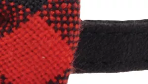 A swatch featuring a red and black plaid pattern composed of overlapping stripes. The woven sections form a diamond‑shaped grid where bright red squares intersect with deeper black tones. Along the right edge is a piece of smooth black material that frames the plaid, emphasizing the bold contrast between fabrics.