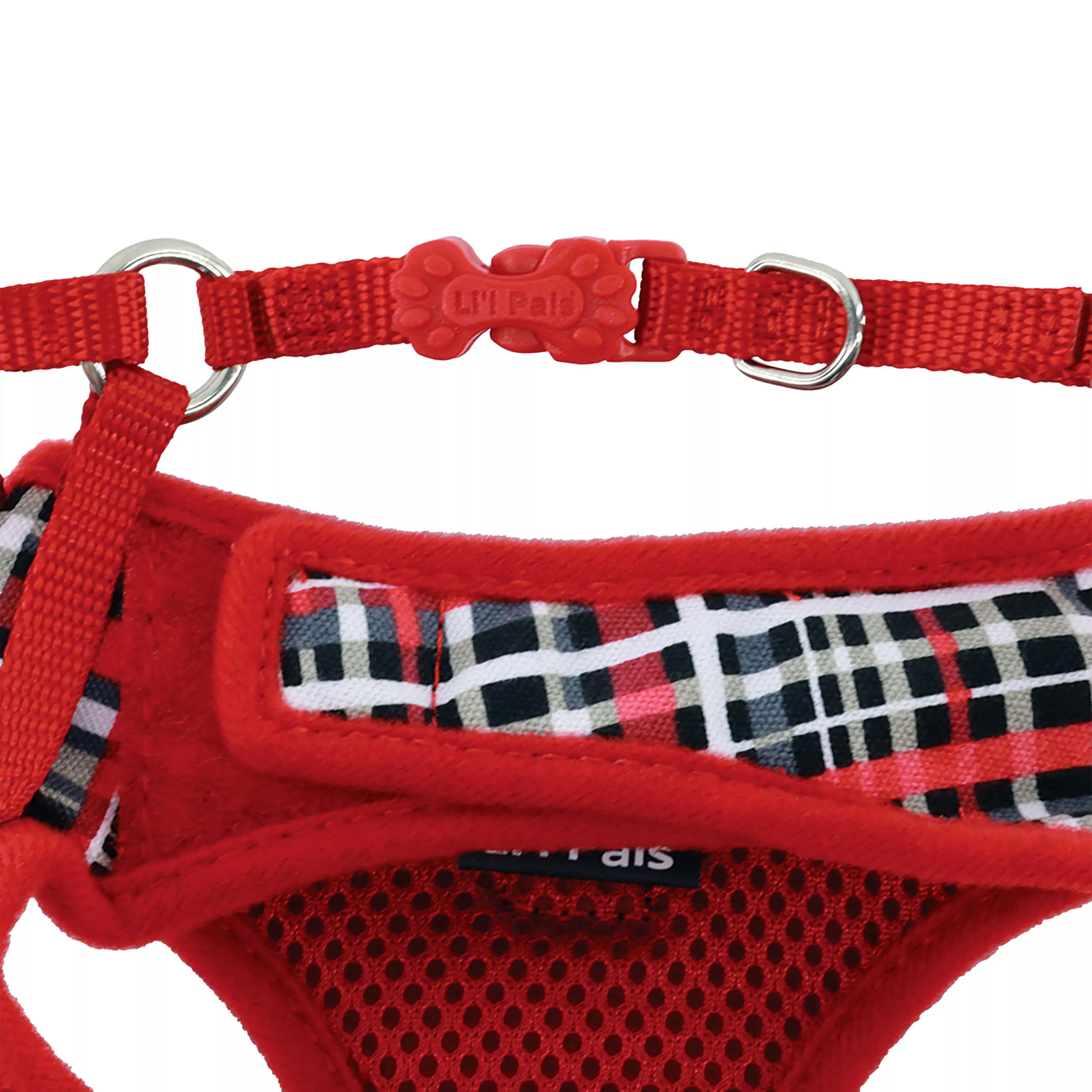 Product image of the Li'l Pals Canvas Dog Harness in Red and Grey Plaid, shown from an angled overhead view on a white background. The harness features red canvas with a plaid patterned back panel and black mesh interior. Adjustable red straps wrap around the sides, meeting at black plastic buckles and a silver D‑ring at the top.