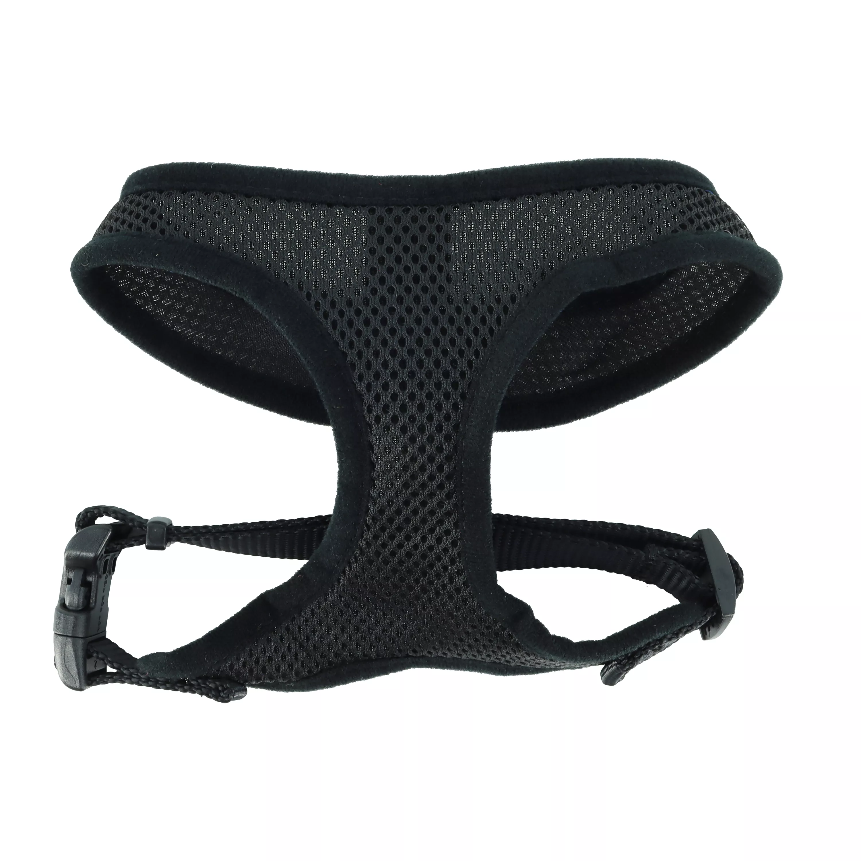 A product‑only image of a black Comfort Soft adjustable mesh dog harness displayed against a white background. The harness includes a padded mesh chest panel with a subtle honeycomb texture and black woven straps with black plastic adjustment sliders. A black plastic side‑release buckle secures the harness, and a silver‑tone metal D‑ring is located at the back strap. The harness is positioned on its side to show strap attachments.