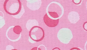 A swatch featuring overlapping circles and dots in multiple shades of pink. The background is light pink, overlaid with medium‑pink and dark‑pink circular shapes in varying sizes and levels of transparency. The design has a bubbly, whimsical aesthetic with smooth print texture.