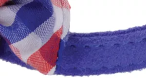 A swatch displaying a decorative bow made from fabric printed in red, white, and blue checkered pattern. The bow is sewn onto a royal‑blue strap with visible texture and stitching. The bow has crisp pleats and rounded edges, giving it a structured, crafted look with soft matte materials.