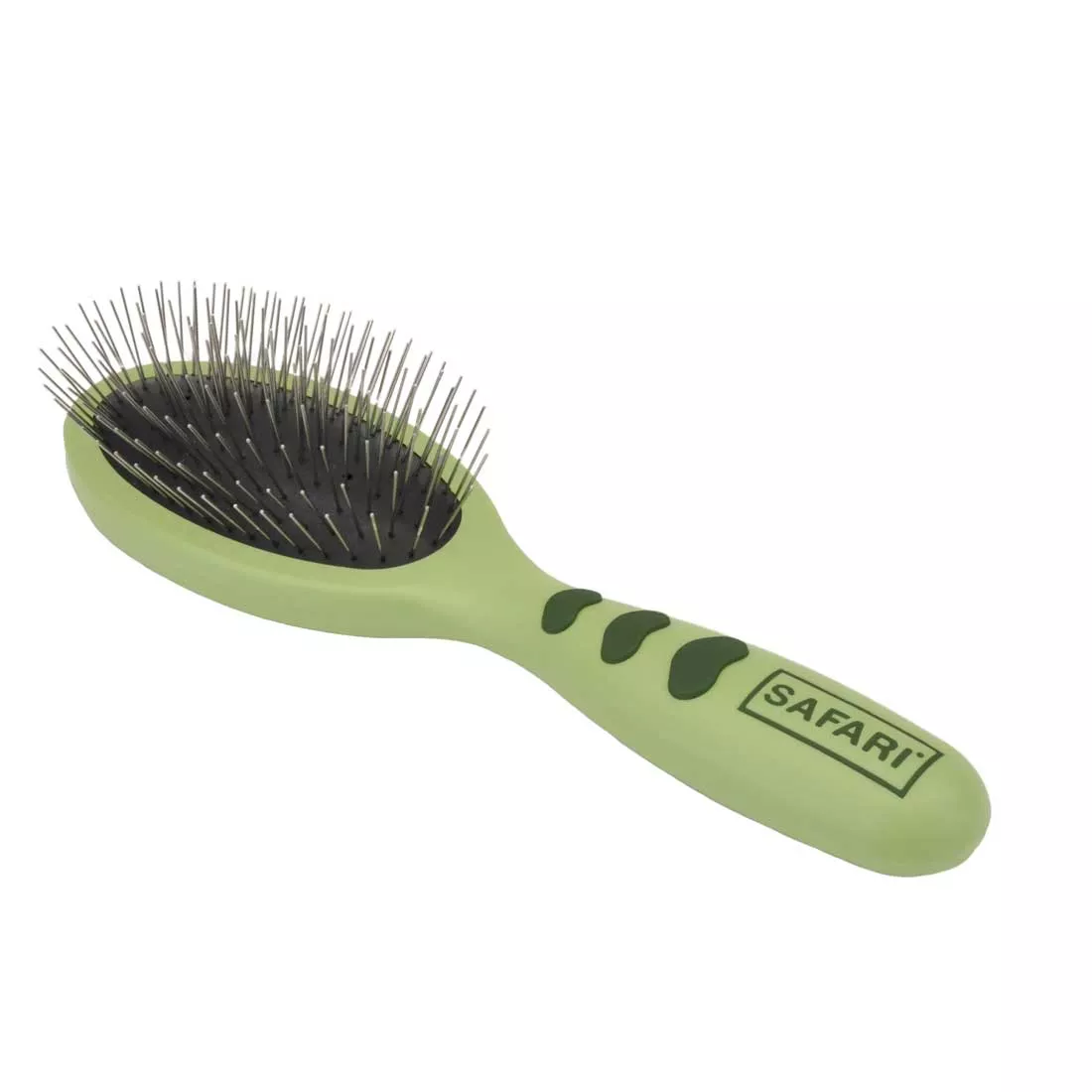 A wire pin brush with a plastic handle shown at a three‑quarter angle on a white background. The oval brush head contains numerous straight metal pins set into a black cushioned pad. The handle is contoured light green plastic with darker green oval‑shaped rubber grip inserts along the underside. Printed text “SAFARI®” appears near the base of the handle.