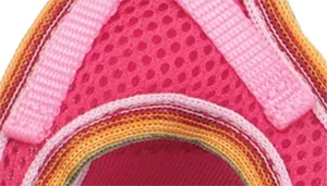 A swatch displays mesh fabric in bright pink. The surface features evenly spaced circular perforations consistent with a mesh structure. Multicolored edge binding is visible, including narrow stripes of yellow, teal, and orange. The pink color is vivid and uniform across the mesh.